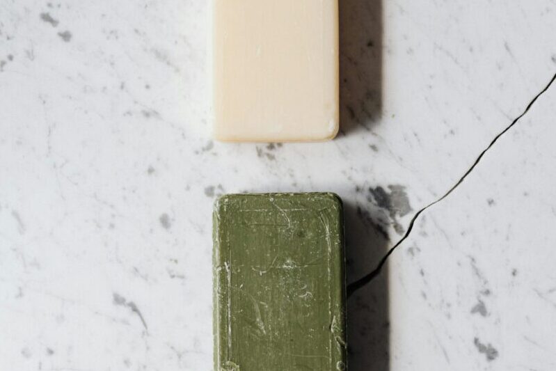 Two soap bars on marble, showcasing elegance and simplicity in a minimalist design.